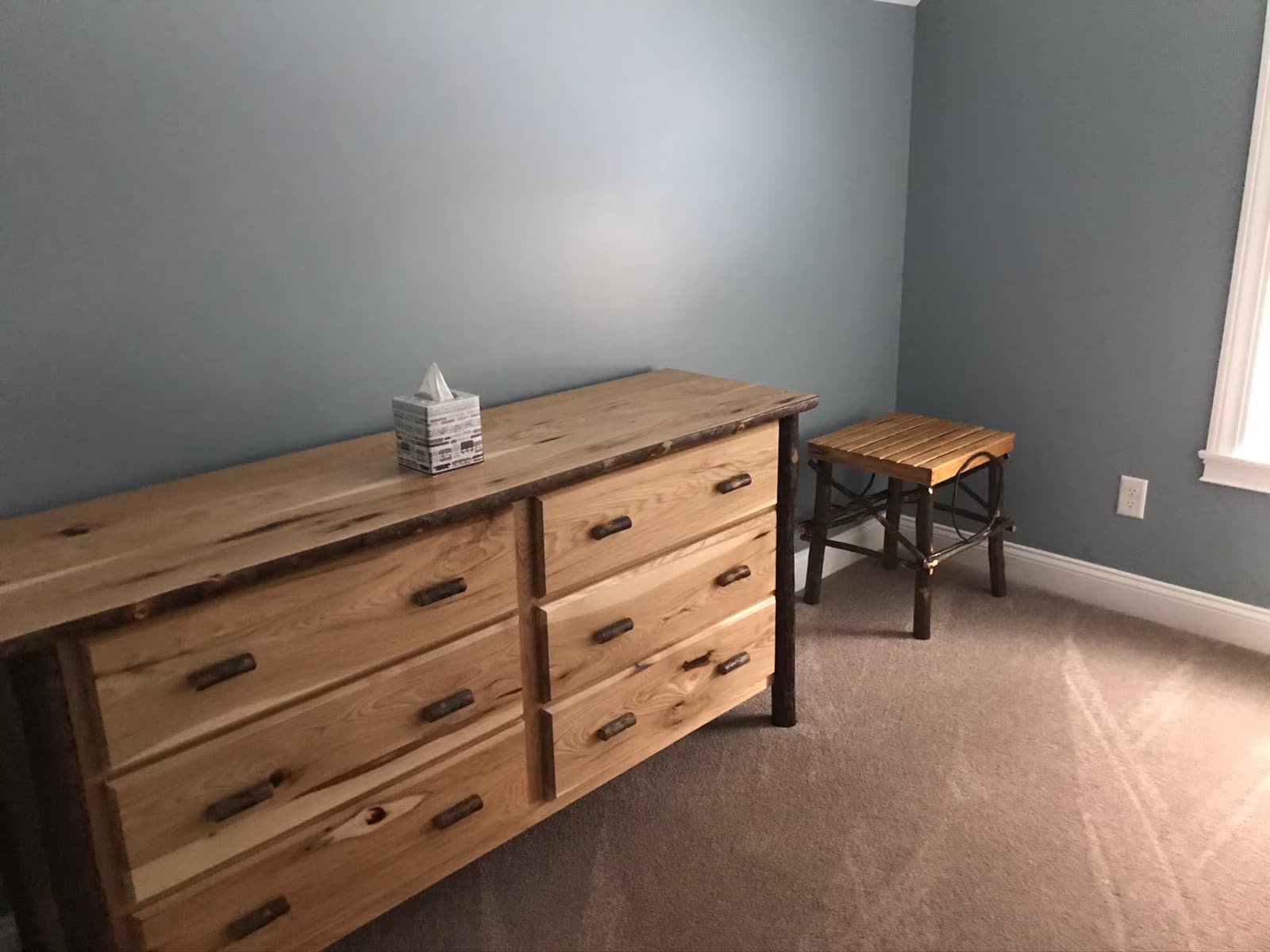 Handmade dresser and stool in a guest bedroom