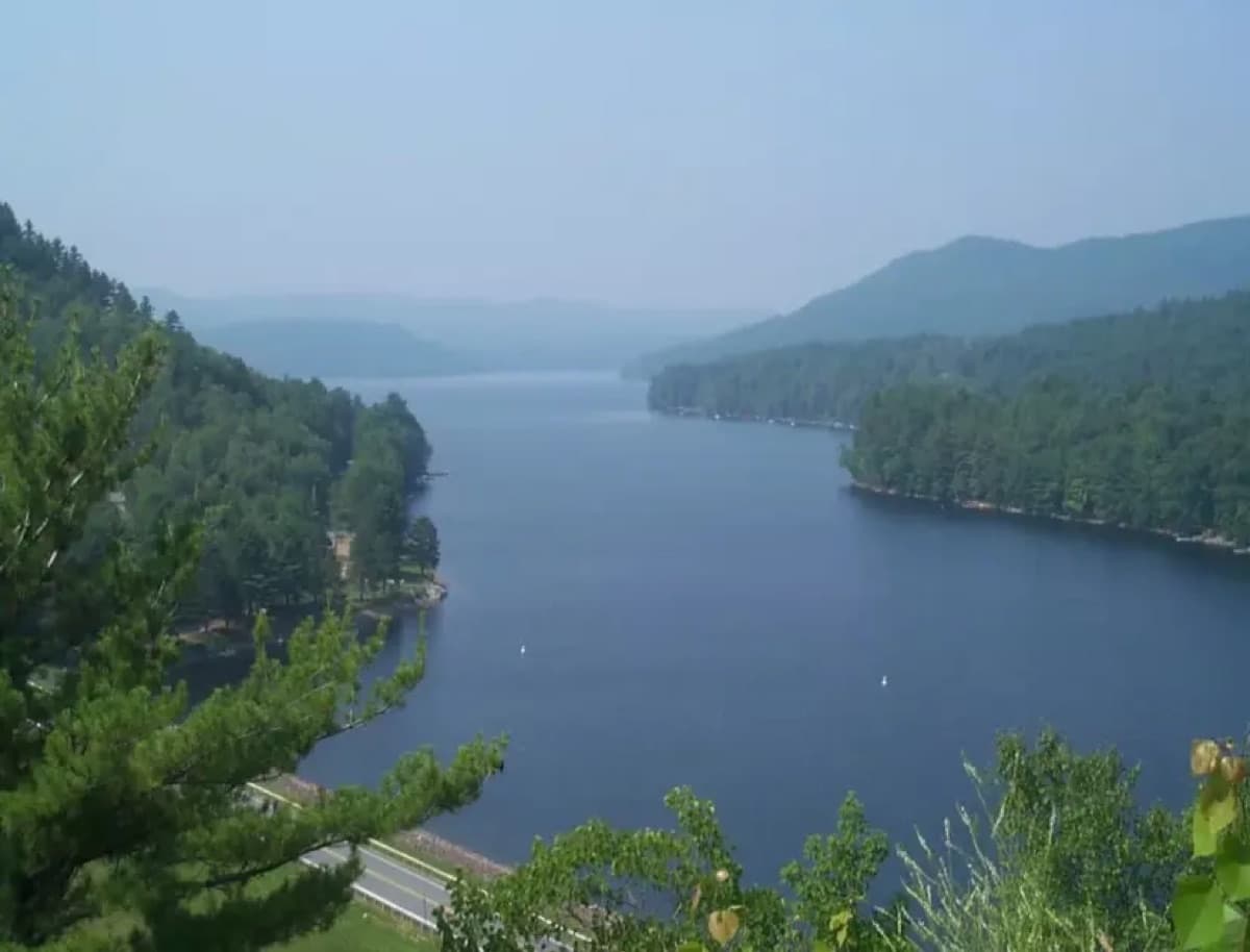 Panoramic view of the lake surrounded by forested hills